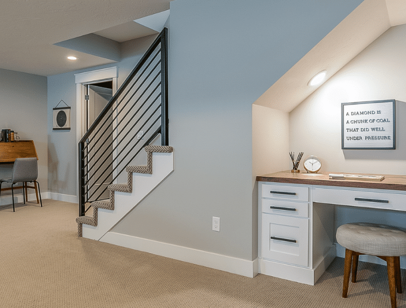 Modern basement office space with stairs and motivational quote on the wall, by remodelers: basement remodelers