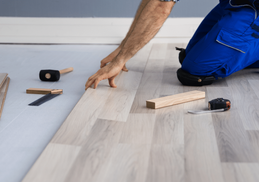 The guy is installing wood flooring and flooring vancouver.