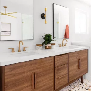 A freestanding double bathroom vanity with a walnut finish, featuring two vessel sinks and round mirrors, set in a modern bathroom.