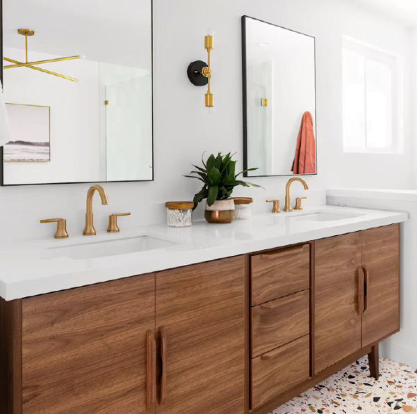 a freestanding double bathroom vanity with a walnut finish, featuring two vessel sinks and round mirrors, set in a modern bathroom.