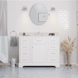 A freestanding single bathroom vanity with a white finish, featuring multiple drawers and cabinets, set against a white subway tile wall in a modern bathroom.