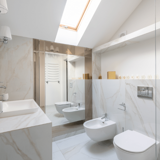 Bright modern bathroom with skylight, marble finishes, and bidet in a bathroom renovation in North Vancouver.