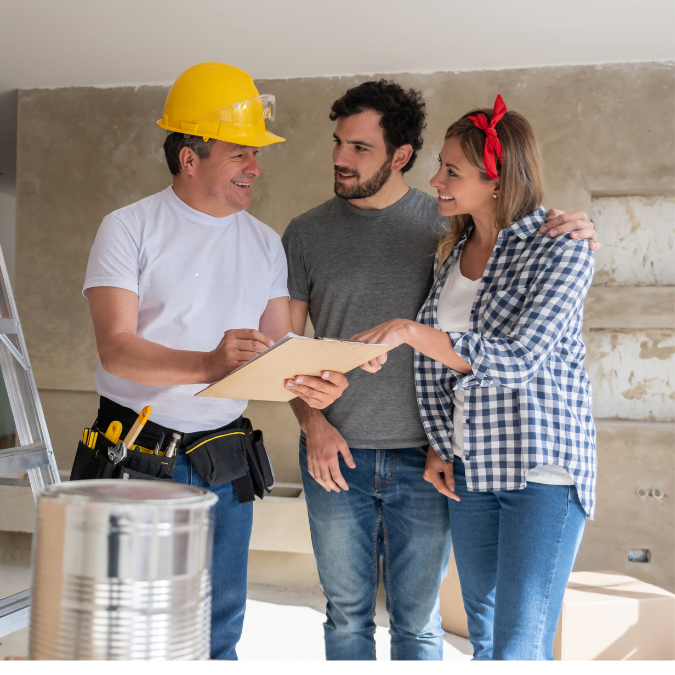 Contractor discussing condo renovation cost with a couple during a home remodel project.