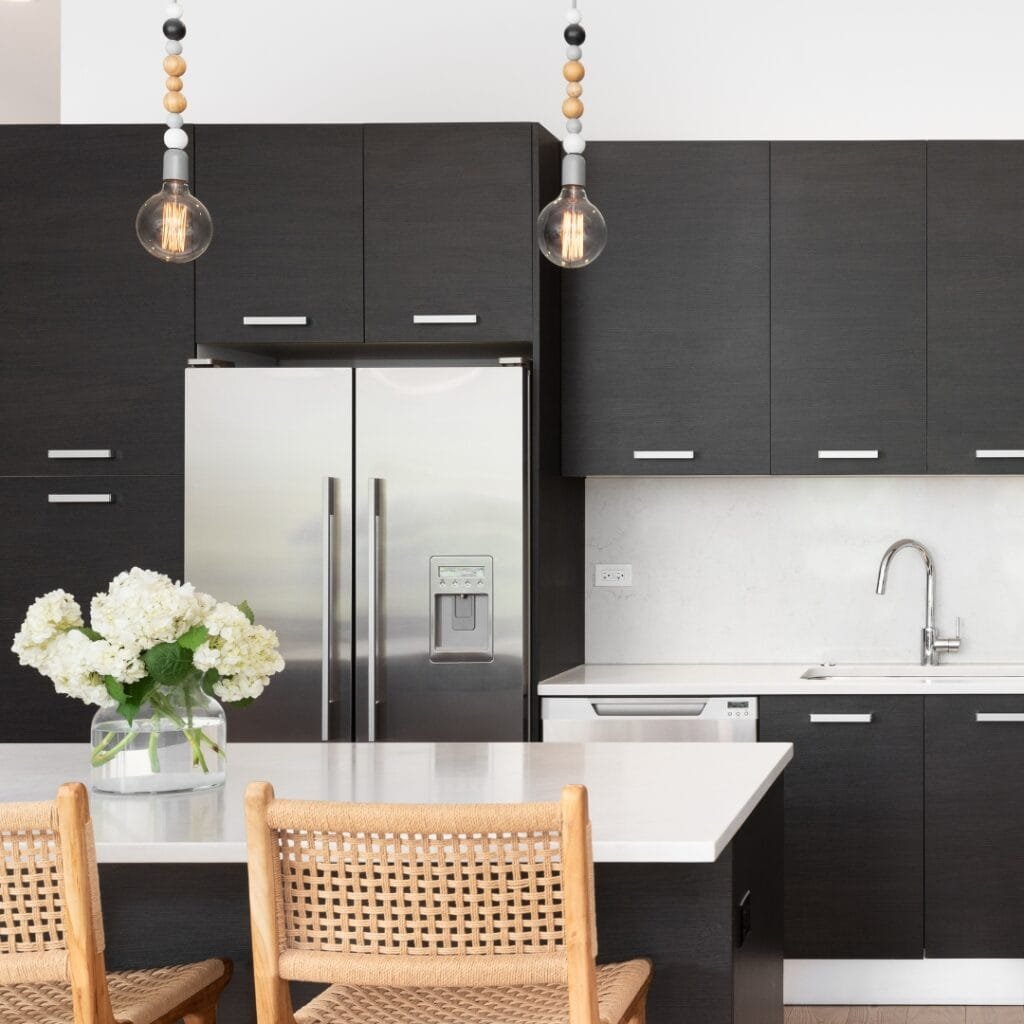 Modern kitchen with quartz countertop and black cabinetry.