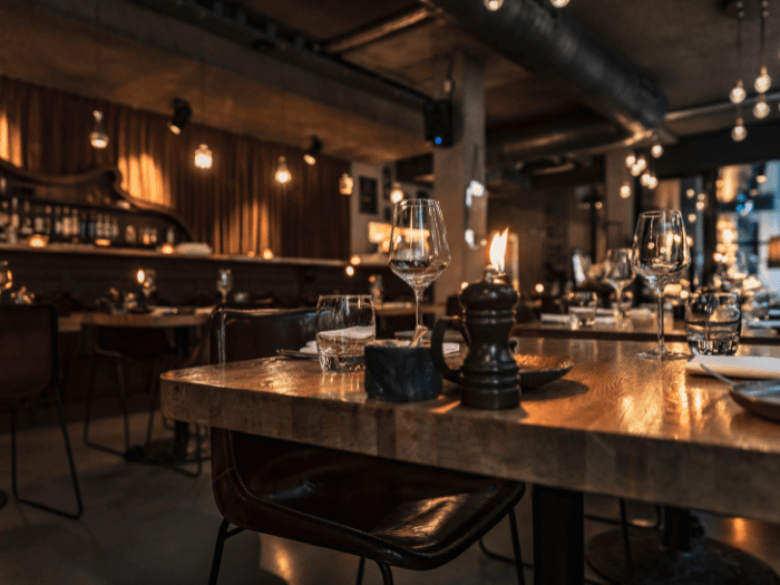 Restaurant remodeling in Vancouver BC with dim lighting, wooden tables, and a cozy atmosphere.