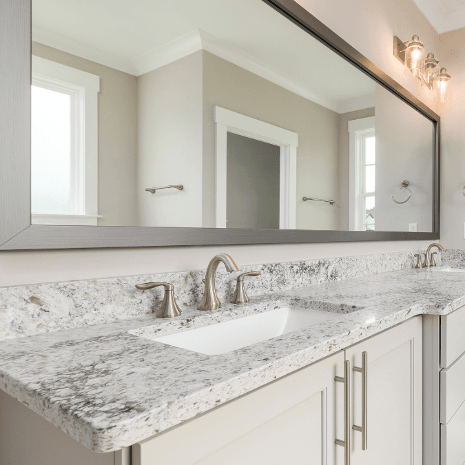 Elegant bathroom countertop with granite finish and dual sinks in a modern bathroom.