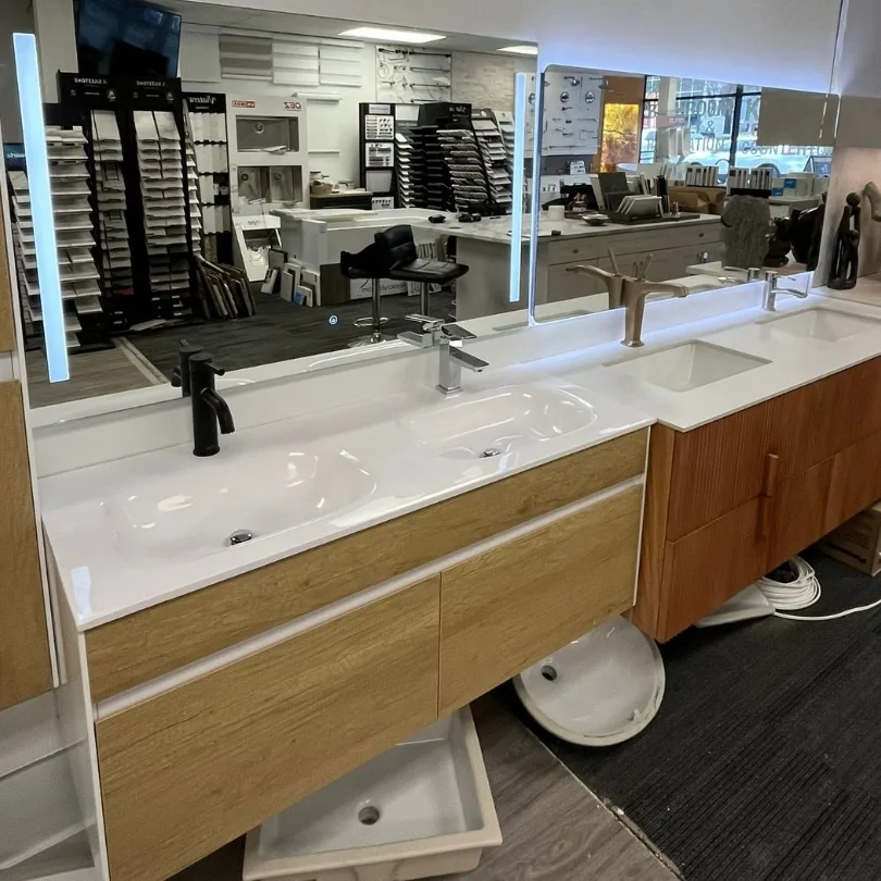 Modern floating vanity with dual sinks, side cabinet, and integrated LED mirrors in a contemporary bathroom setup.