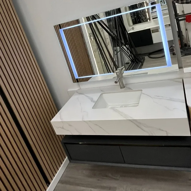 Modern 47-inch floating vanity with a marble countertop, dark cabinet, and illuminated LED mirror.