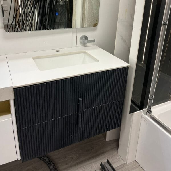 31-inch grey floating bathroom vanity with ribbed cabinet design and sleek white countertop.