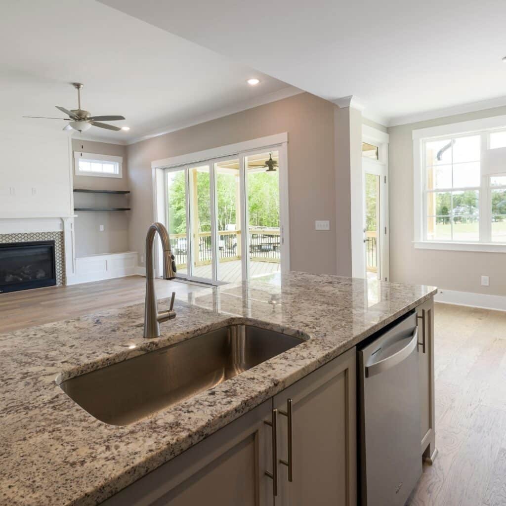 Bright kitchen with granite countertops, built-in sink, and a scenic view of the outdoors