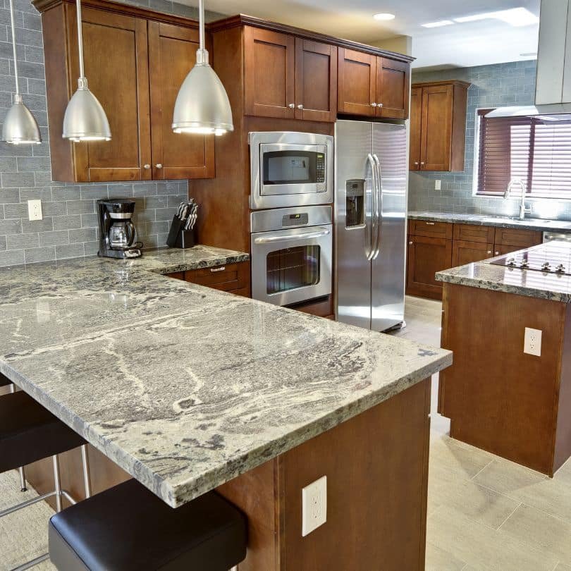 Modern kitchen with polished granite countertops and wooden cabinetry in Vancouver.