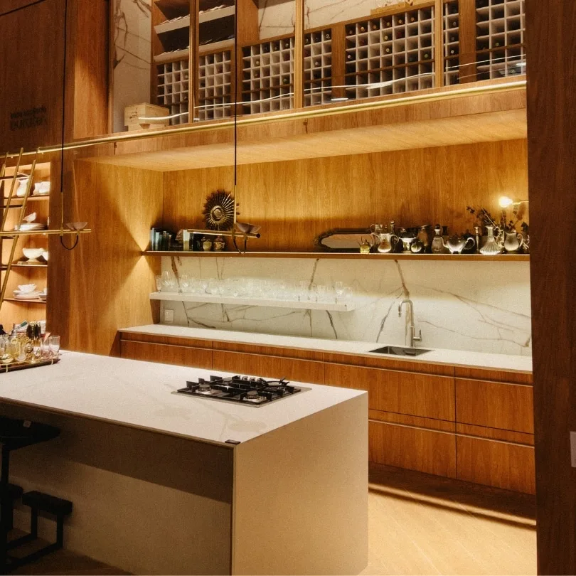 Kitchen remodel in North Vancouver featuring elegant wooden cabinetry, marble backsplash, and a modern island.