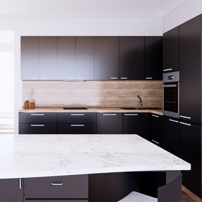 Modern kitchen with black cabinets, wood backsplash, and a white marble island.