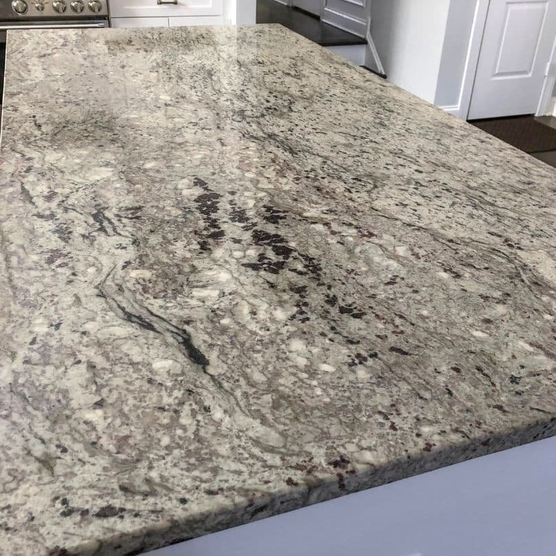 Close-up of a granite countertop with intricate natural patterns, a popular choice among types of kitchen countertops.
