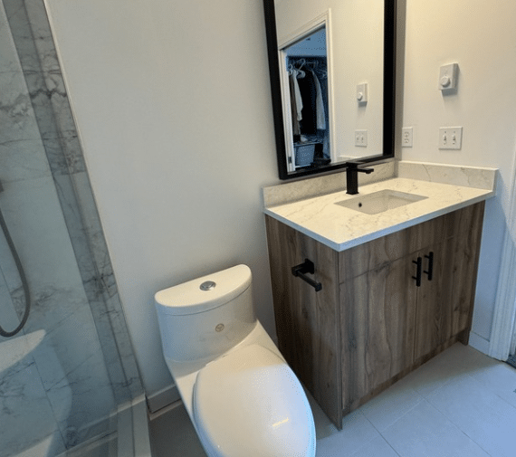 completed bathroom with new fixtures including a toilet and vanity.