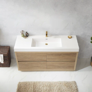 Top view of a modern freestanding bathroom cabinet with a wood finish and white countertop, featuring a gold faucet.