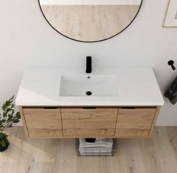 overhead view of a single floating bathroom vanity with a wood finish, white countertop, and black faucet.