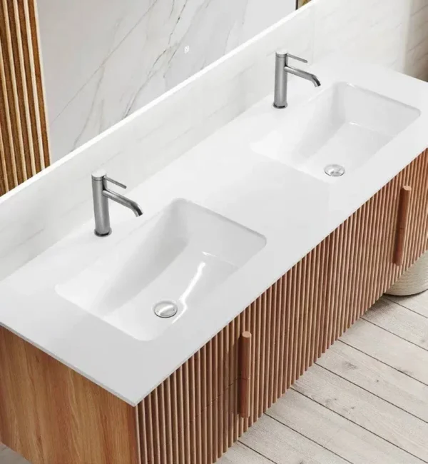 top view of a double sink solid wood bathroom vanity with sleek white basins.