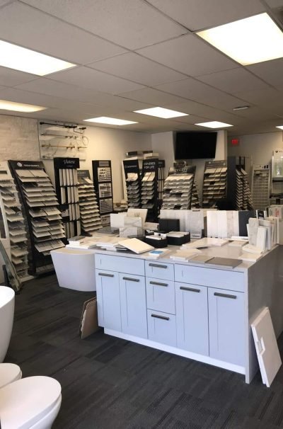 Interior of a home improvement store with various samples of tiles, countertops, and fixtures displayed.